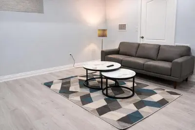 a living room with a couch and a table at Modern 2BR Basement Suite Private Entrance in Brampton