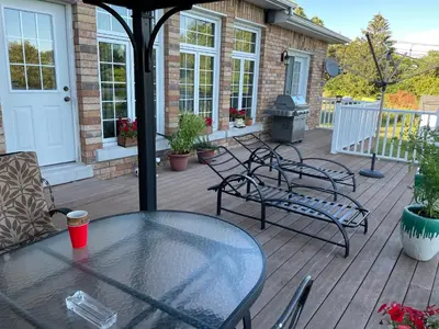 a patio with a table and chairs on a deck at Lakeview in Colborne