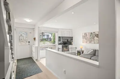 a living room with white walls and a stairway at 4BR Family Home - Dog-Friendly, Huge Yard, 5 Beds in Pickering