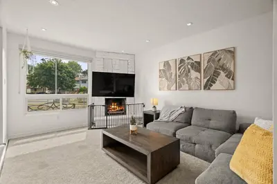 a living room with a couch and a fireplace at 4BR Family Home - Dog-Friendly, Huge Yard, 5 Beds in Pickering