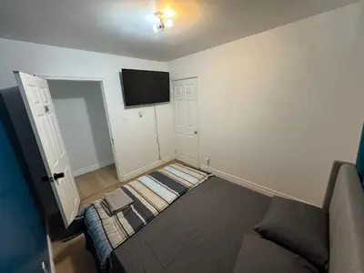 a room with a couch and a flat screen tv at Private Room Near Airport D34 in Mississauga
