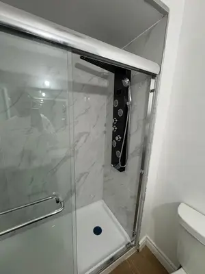 a shower with a glass door in a bathroom at Private Room Near Airport D50 in Mississauga