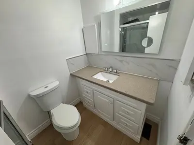 a bathroom with a toilet and a sink and a mirror at Private Room Near Airport D50 in Mississauga