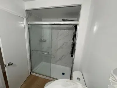 a shower with a glass door in a bathroom at Private Room Near Airport D50 in Mississauga