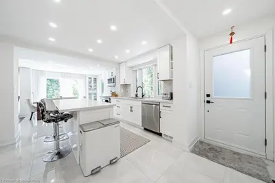 a white kitchen with a desk and a window at Licensed-8 Acre Estate, Trail & Stream with 3 Beds in Hamilton