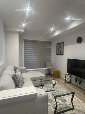 a living room with a couch and a flat screen tv at Modern 3BR FriendlyTown Home in Paris