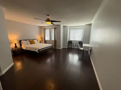 a bedroom with a bed and a ceiling fan at Spacious Three Bedroom House Wifi Parking in Milton