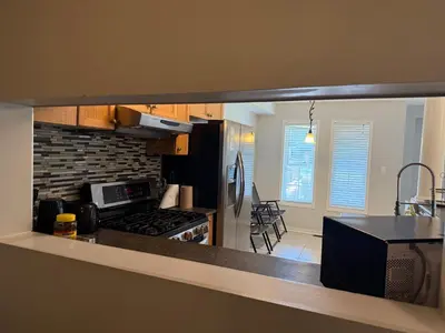 a kitchen with a counter top and a stove top oven at Spacious Three Bedroom House Wifi Parking in Milton
