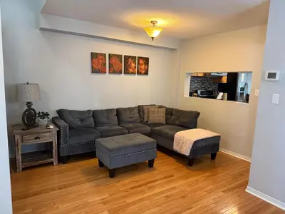 a living room with a couch and a table at Spacious Three Bedroom House Wifi Parking in Milton