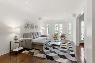 a living room with a couch and a rug at Modern 4BR Retreat with Premium Comforts & Parking in Richmond Hill