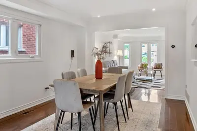 a dining room with a wooden table and chairs at Modern 4BR Retreat with Premium Comforts & Parking in Richmond Hill