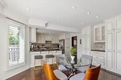 a kitchen with a glass table and chairs at Modern 4BR Retreat with Premium Comforts & Parking in Richmond Hill