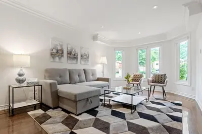a living room with a couch and a table at Modern 4BR Retreat with Premium Comforts & Parking in Richmond Hill