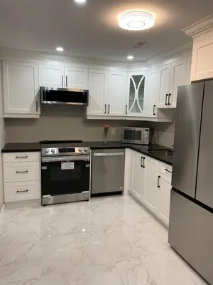 a kitchen with white cabinets and stainless steel appliances at One bedroom and studio Basement Apartment unit sleeps 4 in Oakville