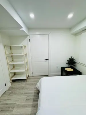 a bedroom with a white bed and a white door at The Urban Executive Suite - Premier Kitchener Loft in Kitchener