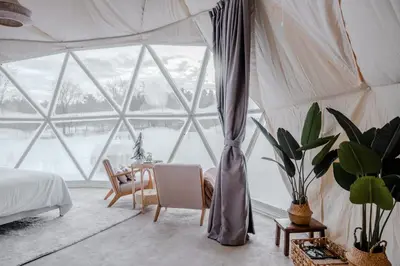 a room with a bed and a table in a tent at 'MoonBeam' Boho-Luxe Glamping Dome at Marmora Retreat in Marmora