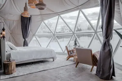 a bedroom with a bed and a large window at 'Twilight' Boho-Luxe Glamping Dome at Marmora Retreat in Marmora