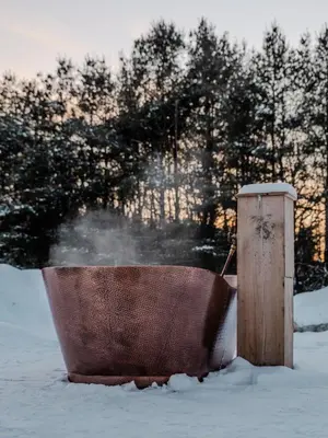 a wooden bath tub sitting in the snow at 'Twilight' Boho-Luxe Glamping Dome at Marmora Retreat in Marmora