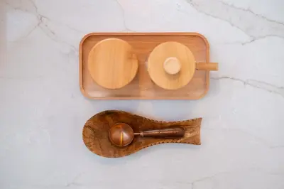 a wooden tray with a wooden spoon on a counter at 'Twilight' Boho-Luxe Glamping Dome at Marmora Retreat in Marmora