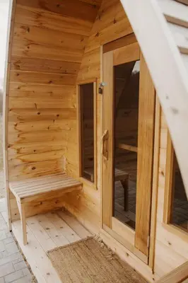 a wooden sauna with a bench inside of it at 'Twilight' Boho-Luxe Glamping Dome at Marmora Retreat in Marmora