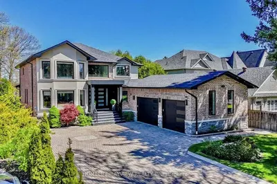 a large brick house with a garage at Luxury Modern Retreat in Richmond Hill in Richmond Hill