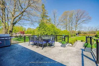 a patio with a table and chairs and a grill at Luxury Modern Retreat in Richmond Hill in Richmond Hill