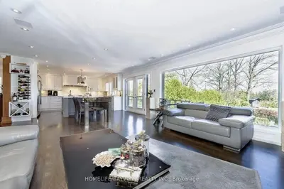a large living room with a couch and a kitchen at Luxury Modern Retreat in Richmond Hill in Richmond Hill