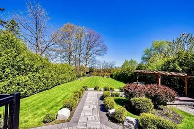 a garden with a stone pathway and bushes at Luxury Modern Retreat in Richmond Hill in Richmond Hill
