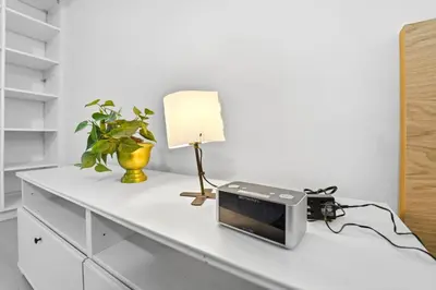 a table with a microwave and a lamp on it at Tranquil Bliss Retreat 9 min to Falls with Free Parking in Niagara Falls