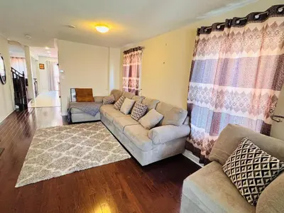 a living room with a couch and two couches at Scarborough Spacious Private Suite 2 Queen Beds & Ensuite in Toronto