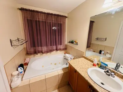 a bathroom with a tub and a sink at Scarborough Spacious Private Suite 2 Queen Beds & Ensuite in Toronto