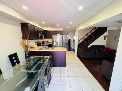 a kitchen and a living room with a counter top at Scarborough Spacious Private Suite 2 Queen Beds & Ensuite in Toronto