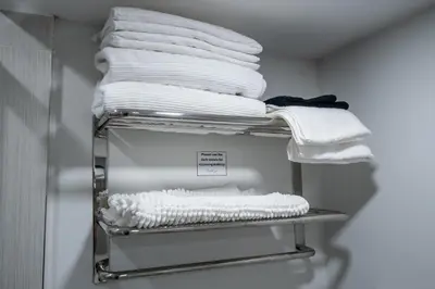 a stack of towels on a shelf in a closet at Newly Renovated 2BR Basement Suite, Private Entry in Pickering