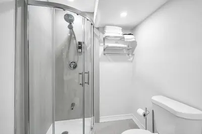 a bathroom with a shower and a toilet at Newly Renovated 2BR Basement Suite, Private Entry in Pickering