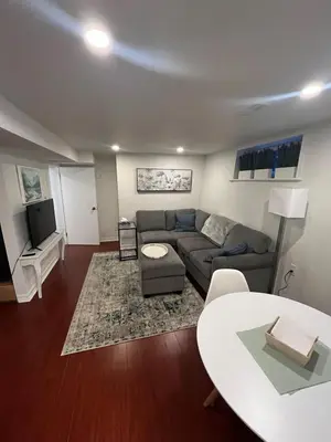 a living room with a couch and a table at 1 Bedroom basement Suite in Junction Bloor West Village in Toronto