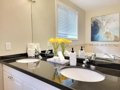 a bathroom with two sinks and a large mirror at Private Ski Chalet Hot Tub & Mountain Views in Blue Mountains