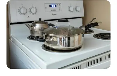 two pots and pans sitting on top of a stove at Bright Room in Walkout Basement in Pickering