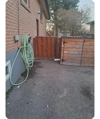 a house with a hose hooked up to a building at Bright Room in Walkout Basement in Pickering