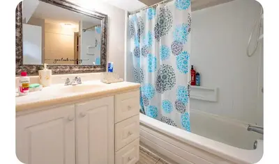 a bathroom with a sink and a shower curtain at Bright Room in Walkout Basement in Pickering