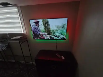 a flat screen tv on the corner of a room at Bright Room in Walkout Basement in Pickering