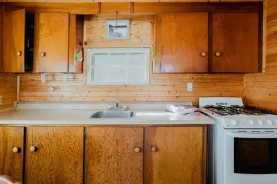 a kitchen with a sink and a stove at Charming Lakeview Family Resort in Katchwanooka with Private BBQ and firepit in Lakefield