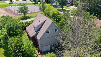an overhead view of a white house with trees at 5 Bedrooms, Mountain Views, Steps from Blue Mountain Village, Hot Tub, BBQ in Blue Mountains