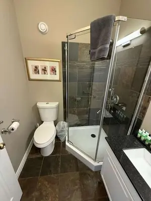 a bathroom with a shower and a toilet and a sink at 5 Bedrooms, Mountain Views, Steps from Blue Mountain Village, Hot Tub, BBQ in Blue Mountains