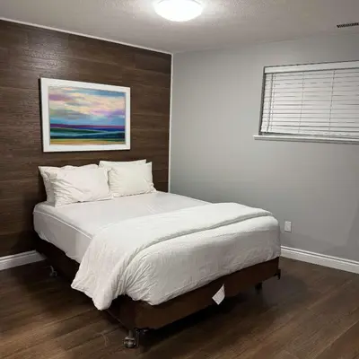 a bedroom with a large bed with a wooden headboard at 5 Bedrooms, Mountain Views, Steps from Blue Mountain Village, Hot Tub, BBQ in Blue Mountains