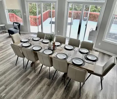 a dining room with a table and chairs at 5 Bedrooms, Mountain Views, Steps from Blue Mountain Village, Hot Tub, BBQ in Blue Mountains