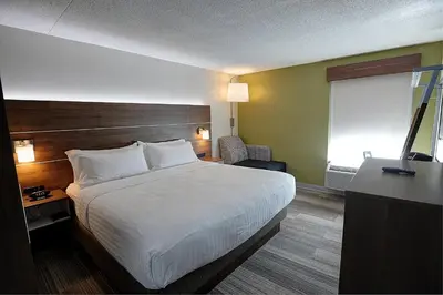 a hotel room with a bed and a television at Holiday Inn Express & Suites Toronto Airport West by IHG in Mississauga