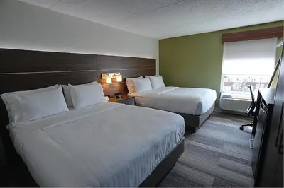 a hotel room with two beds and a window at Holiday Inn Express & Suites Toronto Airport West by IHG in Mississauga