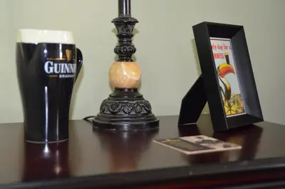 a glass of beer and a picture on a table at Old Town Country Landing in Niagara on the Lake