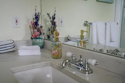a bathroom counter with a sink and a mirror at Old Town Country Landing in Niagara on the Lake