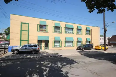 a building with cars parked in front of it at The SoMa Furnished Residences in Hamilton